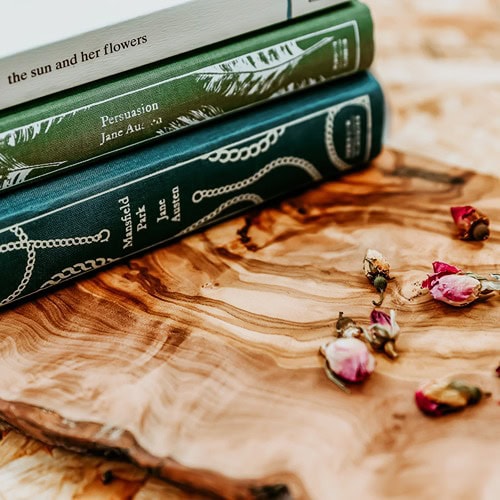 vintage-green-teal-books-on-wooden-background-dried-flowers