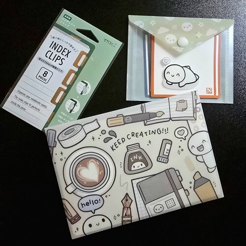 midori index clips, tcmc keep creating envelope, tcmc matcha mini envelope with rocketbook sticky notes on black background